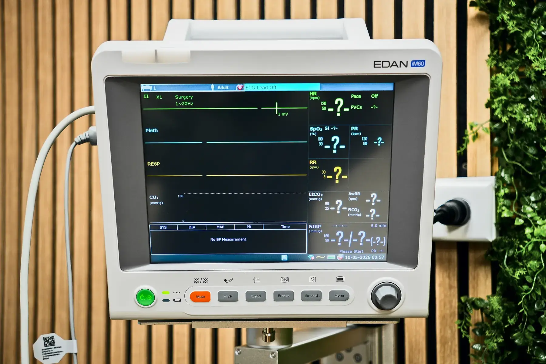 A patient monitor mounted beside the infusion chair