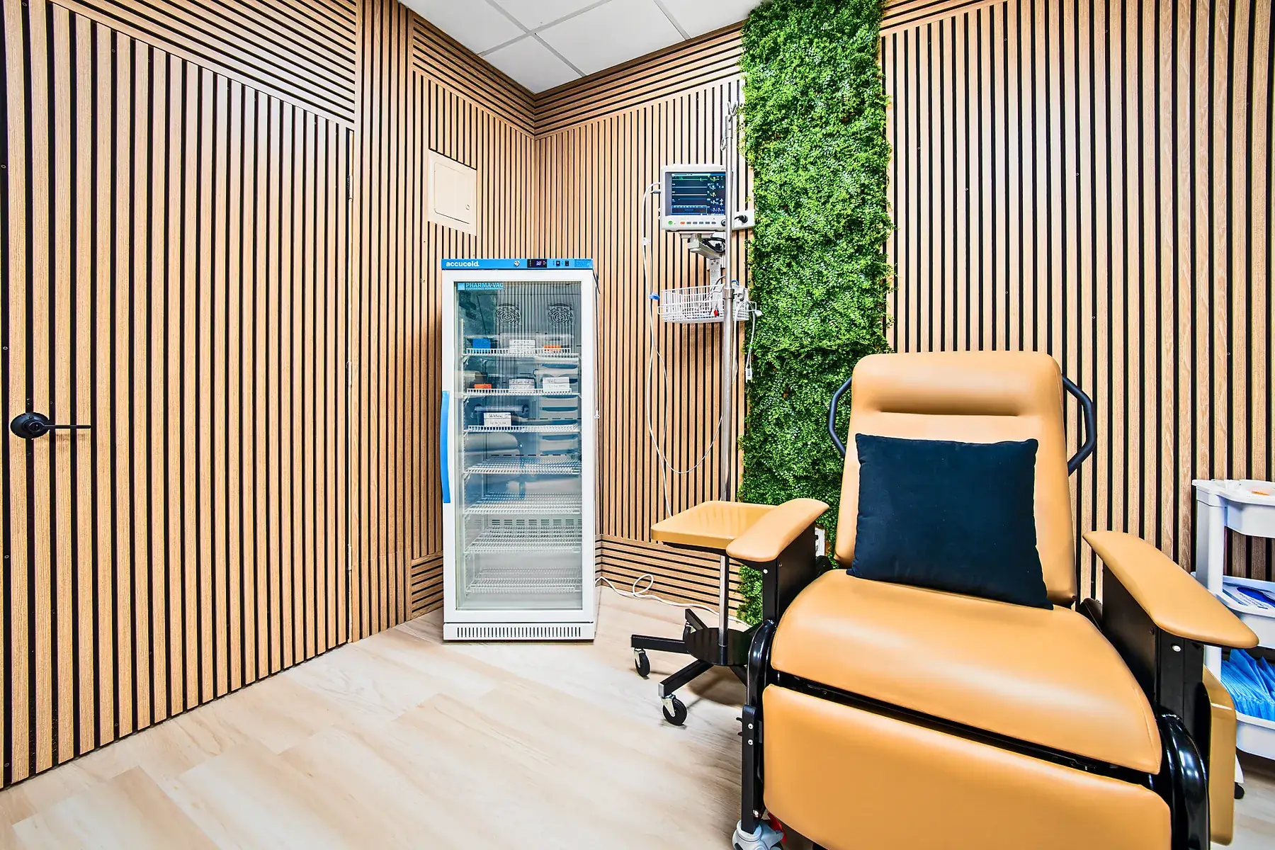A treatment chair beside the medical refrigerator